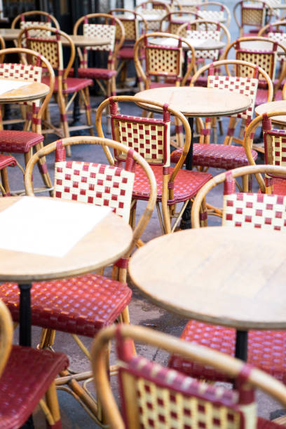 istock Circular cafe tables and chairs outside a cafe in Paris 1407136885