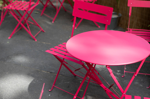 Empty table and chairs outside a cafe in Paris