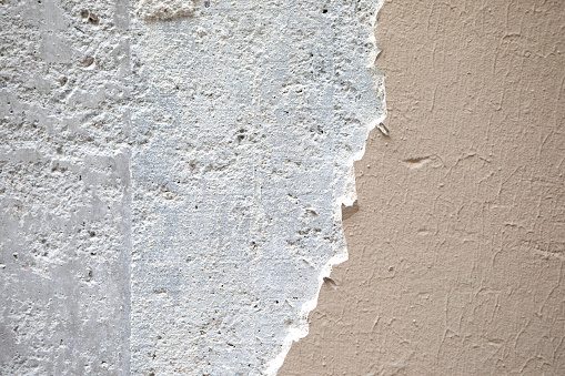 A background of cracked and broken plaster on an outside wall