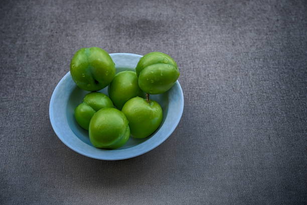 istock Fresh green sour plums harvested from garden now 1407138512