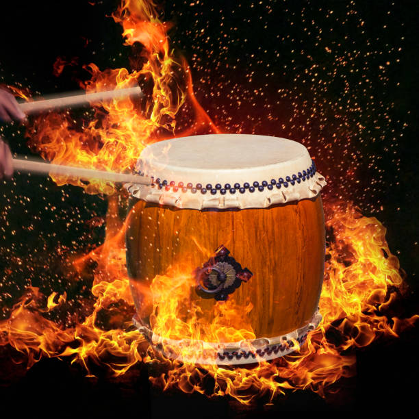 Japanese taiko drum with dancing flames on black background