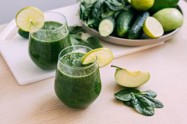 istock Green vegetable fruit smoothie in various glasses light background, Vegetarianism healthy lifestyle 1407139711