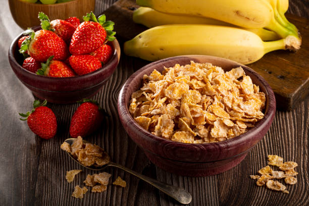 istock Corn flakes in the bowl with berries on the table. 1407140957
