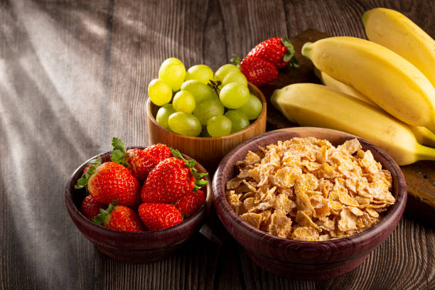 istock Corn flakes in the bowl with berries on the table. 1407141000