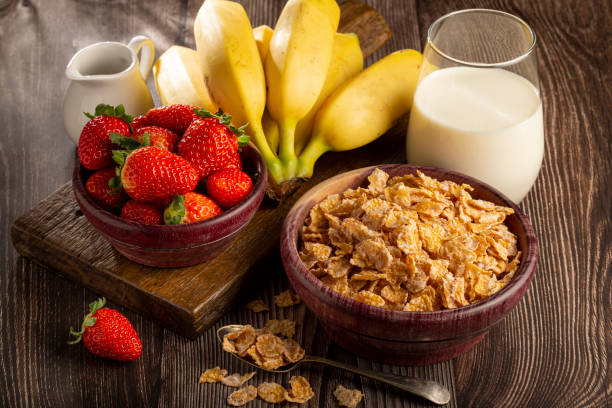 istock Corn flakes in the bowl with berries and milk on the table. 1407141055