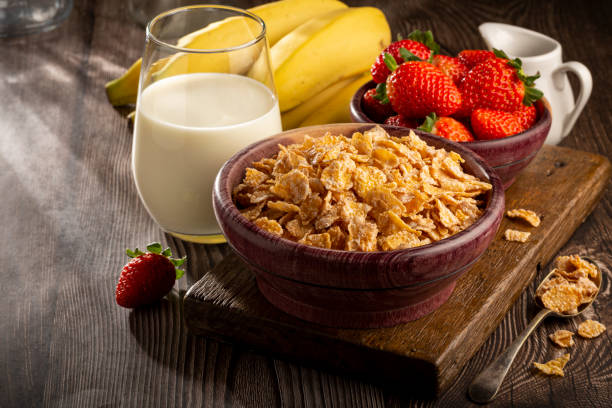 istock Corn flakes in the bowl with berries and milk on the table. 1407141079