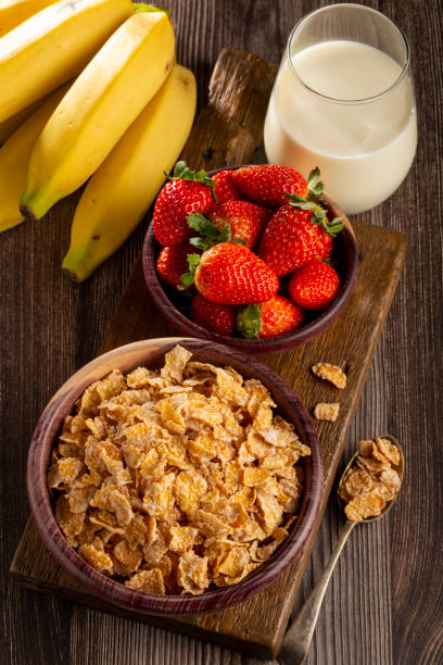 istock Corn flakes in the bowl with berries and milk on the table. 1407141085