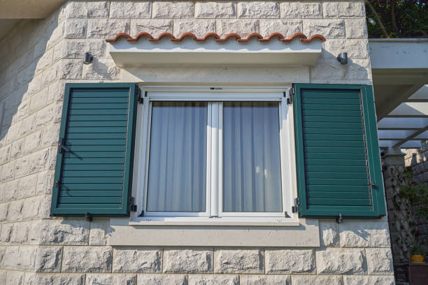 White window in a house with open plastic shutters stock photo