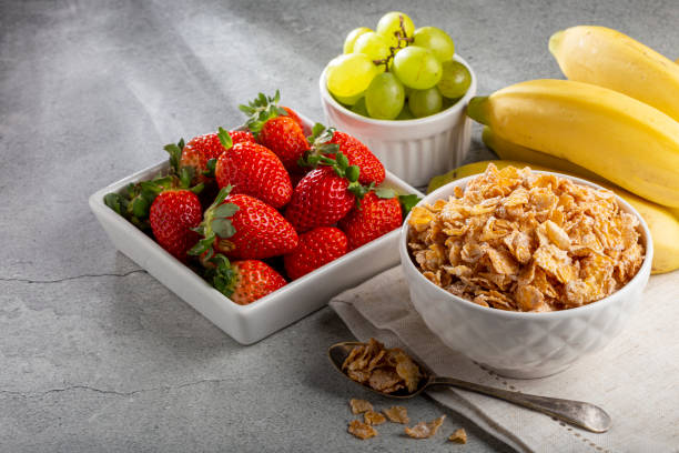 istock Corn flakes in the bowl with berries on the table. 1407141205