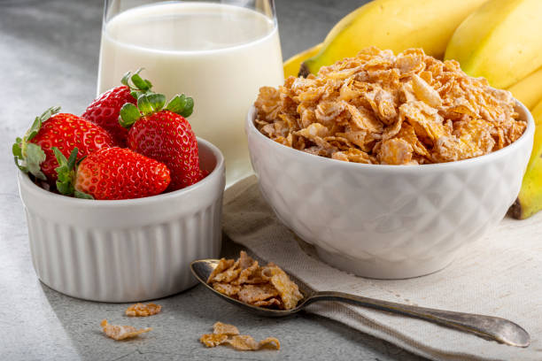 istock Corn flakes in the bowl with berries and milk on the table. 1407141230
