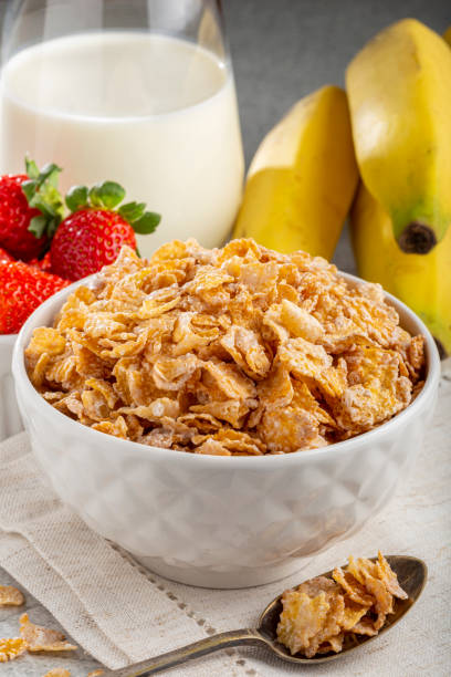 istock Corn flakes in the bowl with berries and milk on the table. 1407141243