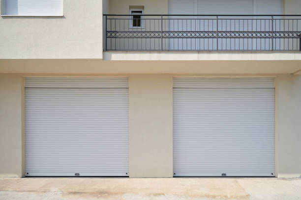 istock Two garages with white garage doors in a residential building 1407141257
