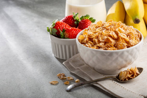 istock Corn flakes in the bowl with berries and milk on the table. 1407141258