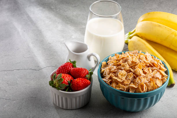 istock Corn flakes in the bowl with berries and milk on the table. 1407141359