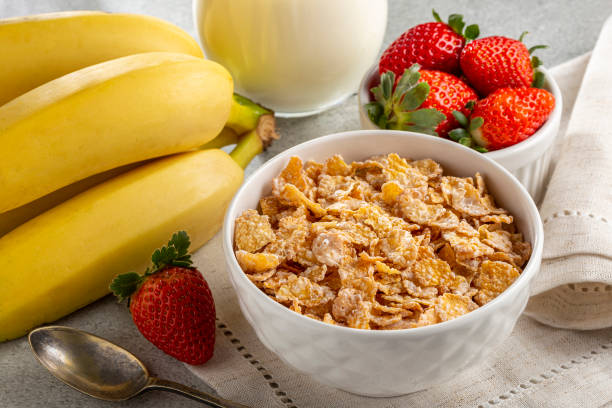 istock Corn flakes in the bowl with berries and milk on the table. 1407141397