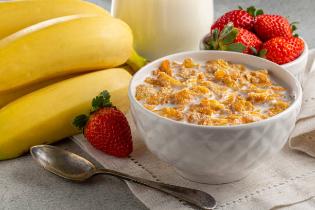 istock Corn flakes in the bowl with berries and milk on the table. 1407141420