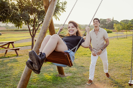 Young couple swinging open venue in Holambra, Brazil
