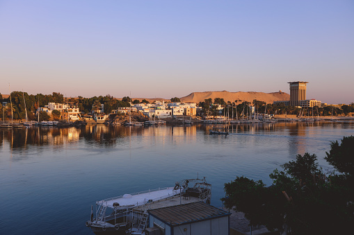 Sunset View to the Panoramic Aswan cityscape with the Palm Trees, Egypt