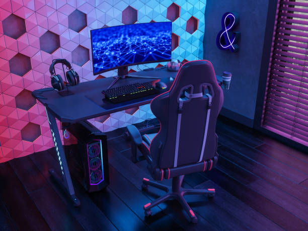 игровая комната с и�гровым креслом, монитором компьютера и неоновыми огнями ночью - gamer стоковые фото и изображения
