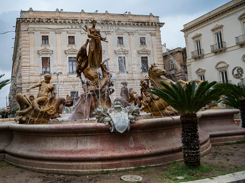 The Fountain of Diana (Fontana di Diana) is in the center of Piazza Archimede in Syracuse on the east coast of Sicily. It is also known as the Fountain of Artemis, as the original Greek name