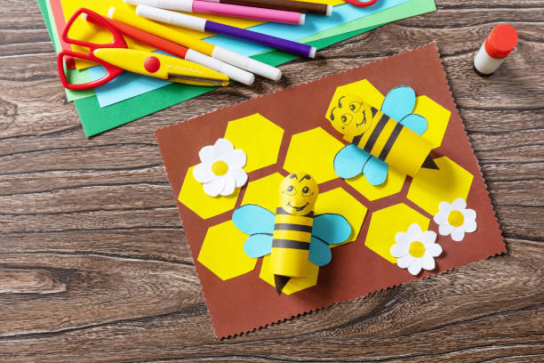 istock Summer card with voluminous bees on a wooden table. Handmade. Childrens creativity project, crafts for kids. 1407143804