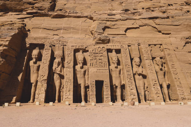 The main view of an Entrance to the Great Temple at Abu Simbel with Ancient Colossal statues of Ramesses II The main view of an Entrance to the Great Temple at Abu Simbel with Ancient Colossal statues of Ramesses II, seated on a throne and wearing the double crown of Upper and Lower Egypt temple of luxor hypostyle hall stock pictures, royalty-free photos & images