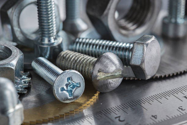 istock set of different nuts, bolts, screws, washers and drill bits,thread tap and mill cutters on steel plate background. Locksmithing deal. 1407144460
