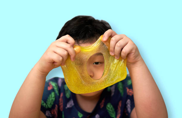 kid play slime peeking through stock photo