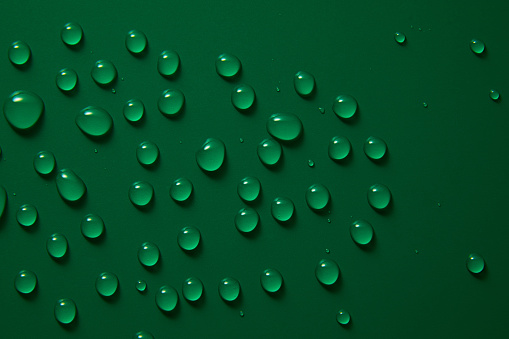 Abstract water drops on green background, macro, Bubbles close up, Cosmetic liquid drops, Flat lay pattern.