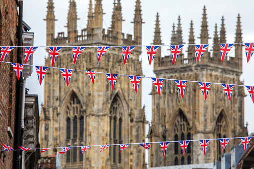 Union flag bunting hanging in the beautiful city of York, in the UK. The historic York Minster pictured in the background.