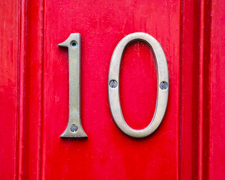 Close-up of the Number 10 on a red door.
