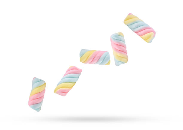 Colorful marshmallows candy falling in the air isolated on white