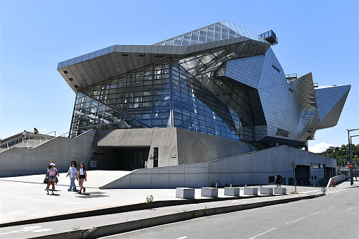 Lyon, France-06 25 2022: People in front of the Musée des Confluences.The Musée des Confluences is a science centre and anthropology museum which opened in 2014 in Lyon, France. It is located at the southern tip of the Presqu'île at the confluence of the Rhône and the Saône, and comprises part of a larger redevelopment project of the Confluence quarter of Lyon.
