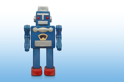 front view blue and silver and red zinc robot toy standing on gradient white and blue background, object, fashion, gift, decor, copy space