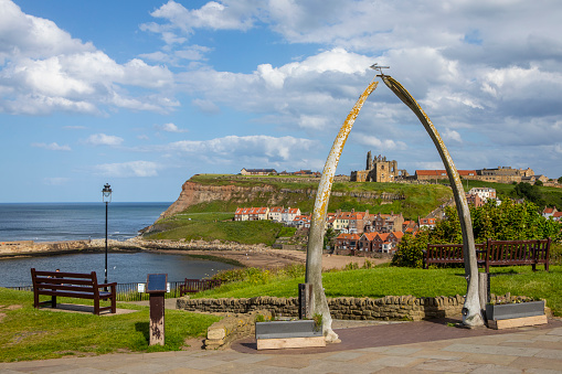 The Whale Bone Arch in the beautiful seaside town of Whitby in North Yorkshire, UK.  St. Marys Church and the remains of Whitby Abbey can be seen in the distance.