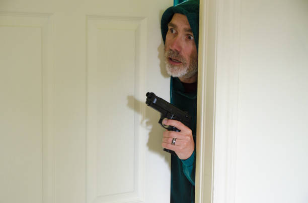 istock Armed man looking out of bedroom door 1407152182