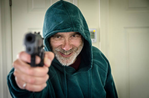 Adult man with gun at dark spooky building. Actor-model performing.