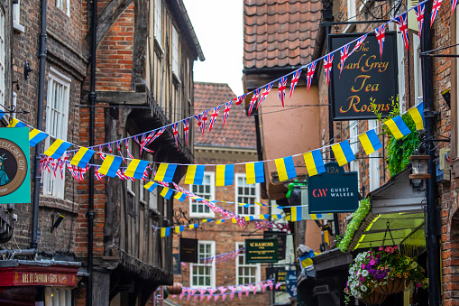 York, UK - June 6th 2022: Union Flag and Ukrainian flag bunting hanging over The Shambles in the city of York, UK.