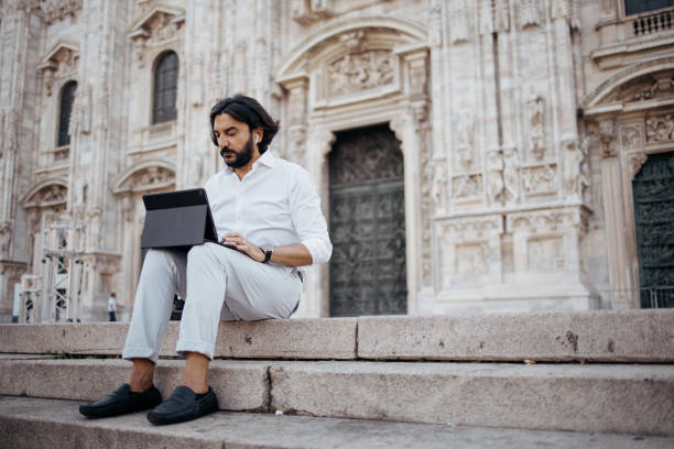 mature businessman using a digital tablet to work outside - travel passenger milan italy italy imagens e fotografias de stock