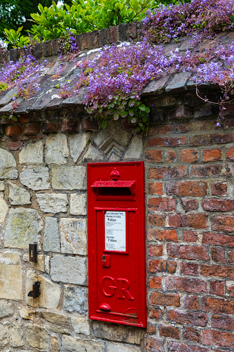 York, UK - June 6th 2022: A red post box in the beautiful city of York, in the UK.