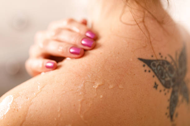 istock Woman pouring water on shoulder with her hand 1407157246