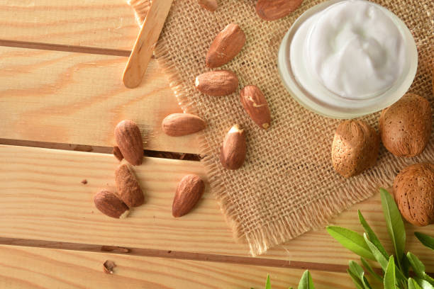 istock Moisturizing cream with almond extract on wooden table close up 1407157959