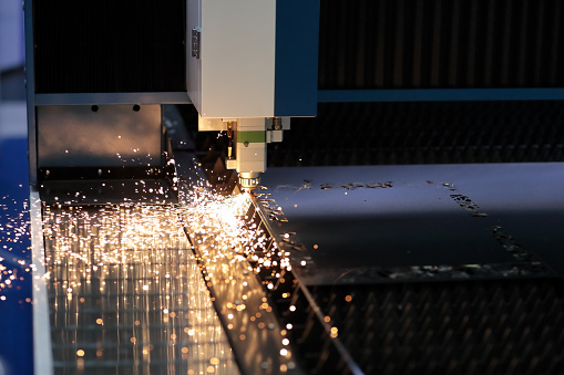 Metal sheet cutting process with CNC laser cutting machine. Selective focus.