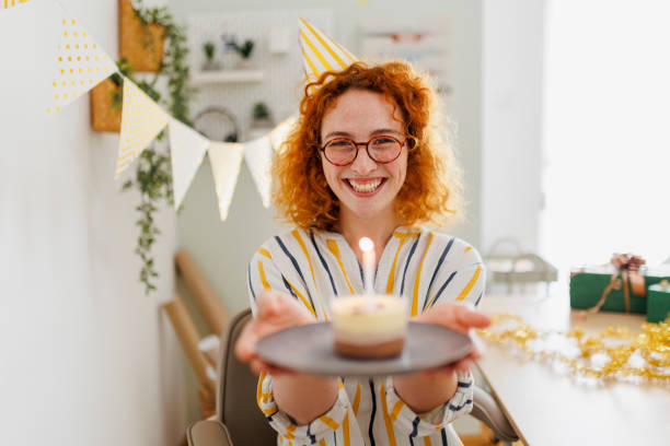 Beautiful young woman celebrating birthday in her office Beautiful young woman celebrating birthday in her office woman birthday cake stock pictures, royalty-free photos & images