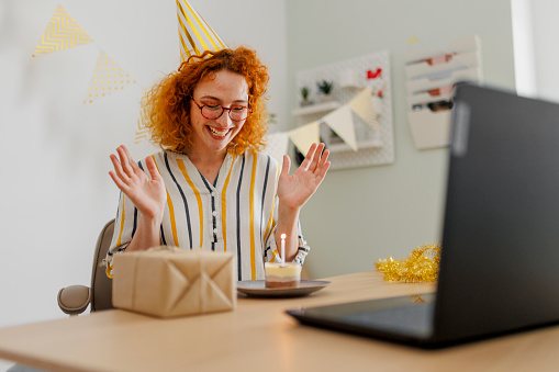 Young woman celebrating birthday in her office