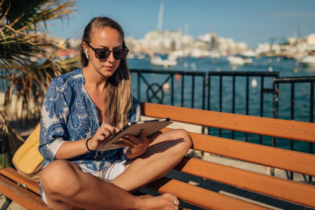 istock A female freelancer uses a digital tablet to complete work remotely 1407159315