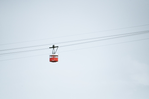 A hanging red cable car