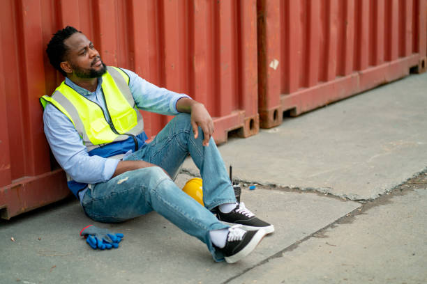 istock African American cargo container worker or technician sit and lean on container tank and action look like tired after work in workplace area for long time. 1407160175