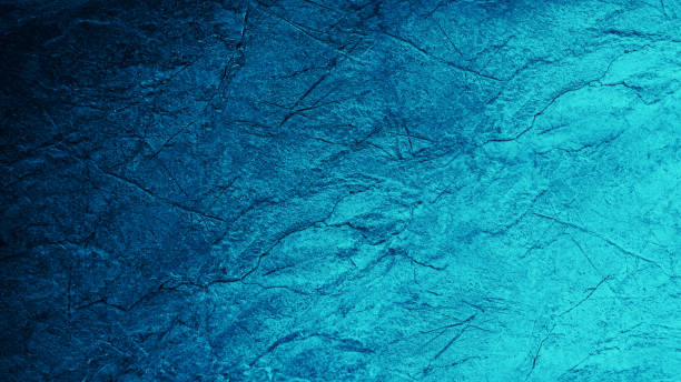istock Blue teal green abstract background. Gradient. Toned rough texture of a rock surface with cracks. 1407160262