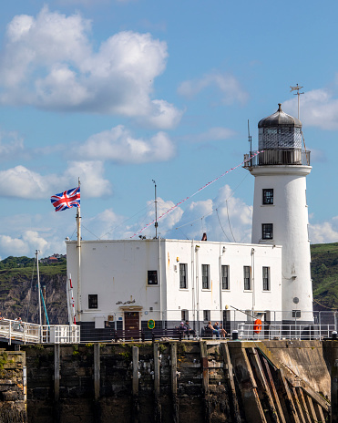 Scarborough, UK - June 8th 2022: A view of Scarborough Pier Lighthouse in the seaside town of Scarborough in North Yorkshire, UK.